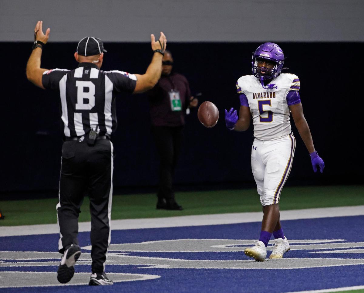 Alvarado wide receiver Demarcus Belton tosses the ball to back judge Jamey Cantrell after scoring during the Indians’ 44-41 double-overtime victory over Frisco Panther Creek in a Class 4A Division I area playoff last season at the Ford Center in Frisco.