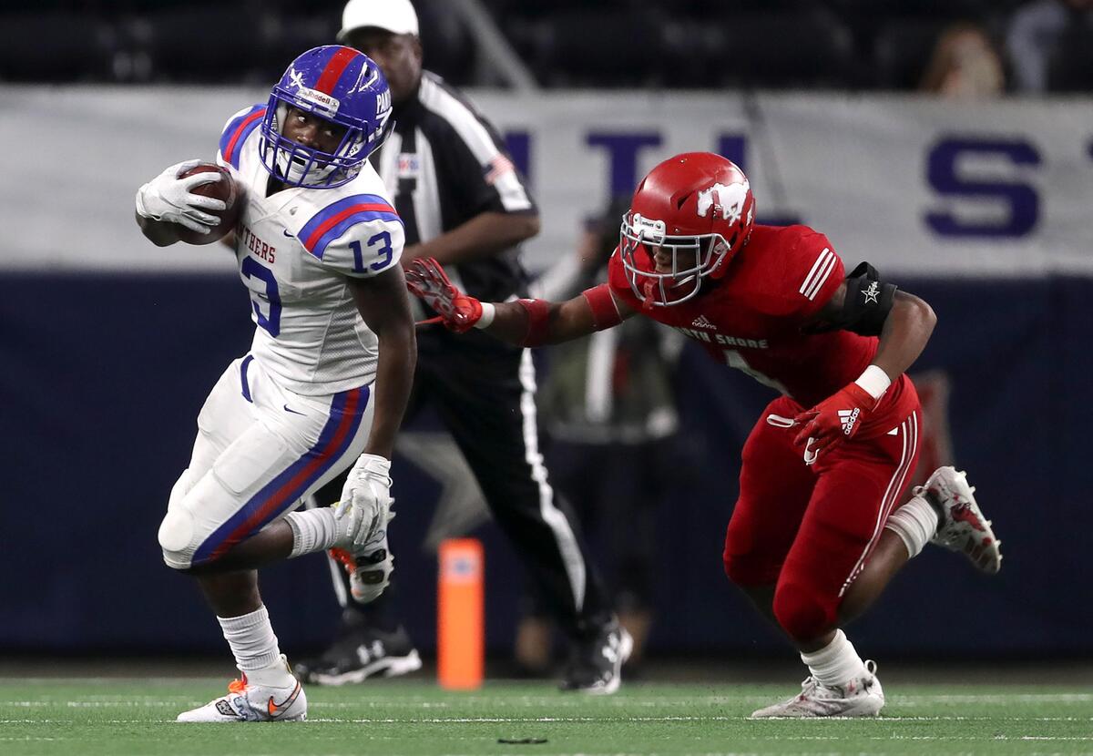 Duncanville wide receiver Roderick Daniels (13) tries to get around North Shore linebacker Corey Flagg (1) during the first half of the 6A Division I High School State Football Championship game played at AT&T Stadium in Arlington, TX, Saturday, December 21, 2019.