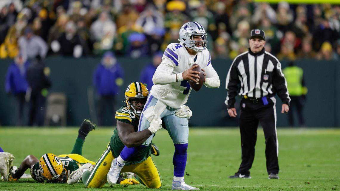 Green Bay Packers defensive tackle Jarran Reed (90) sacks Dallas Cowboys quarterback Dak Prescott (4) during an NFL football game on Sunday at Lambeau Field.