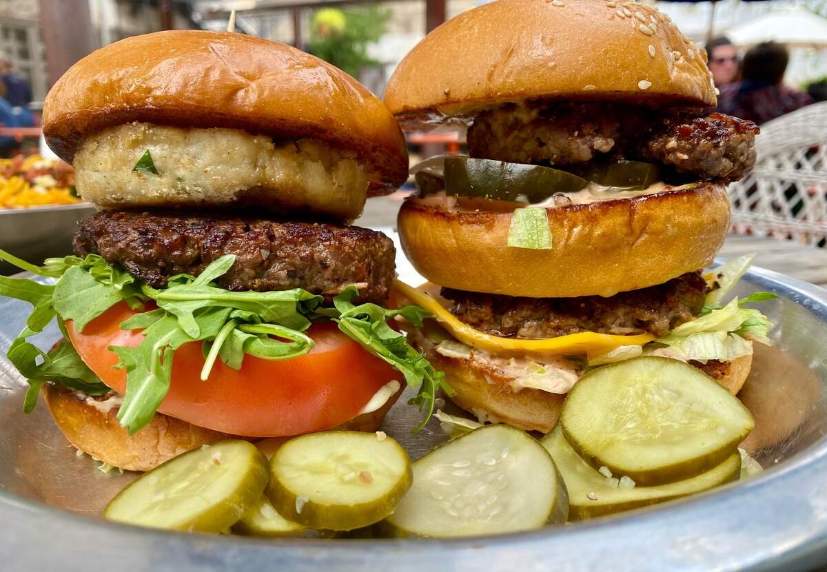 Rodeo Goat’s “Battle of the Burgers” pits a crabcake-burger “Biden,” left, against “The McDonald,” a double-decker burger at right.