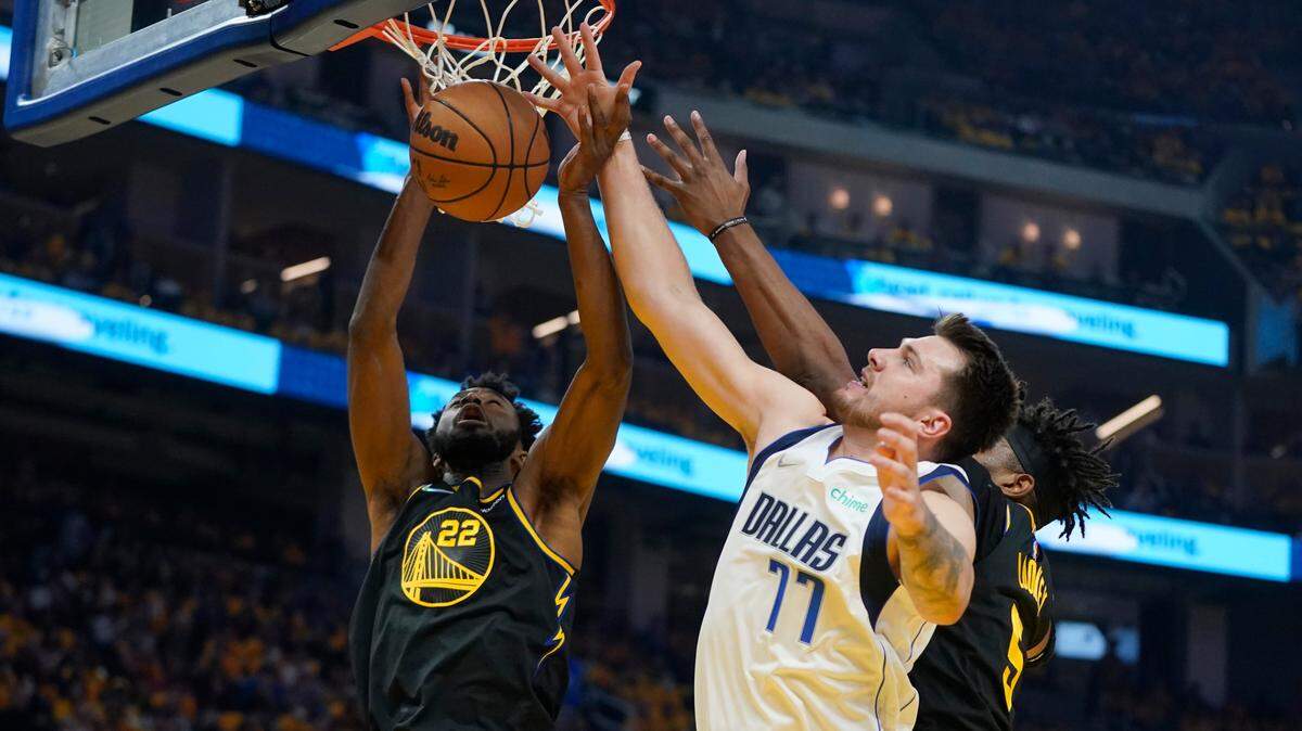 Andrew Wiggins, left, Kevon Looney, right, and the Golden State Warriors had the upper hand on Luka Doncic (77) and the Dallas Mavericks on Thursday in Game 5 of the Western Conference Finals.