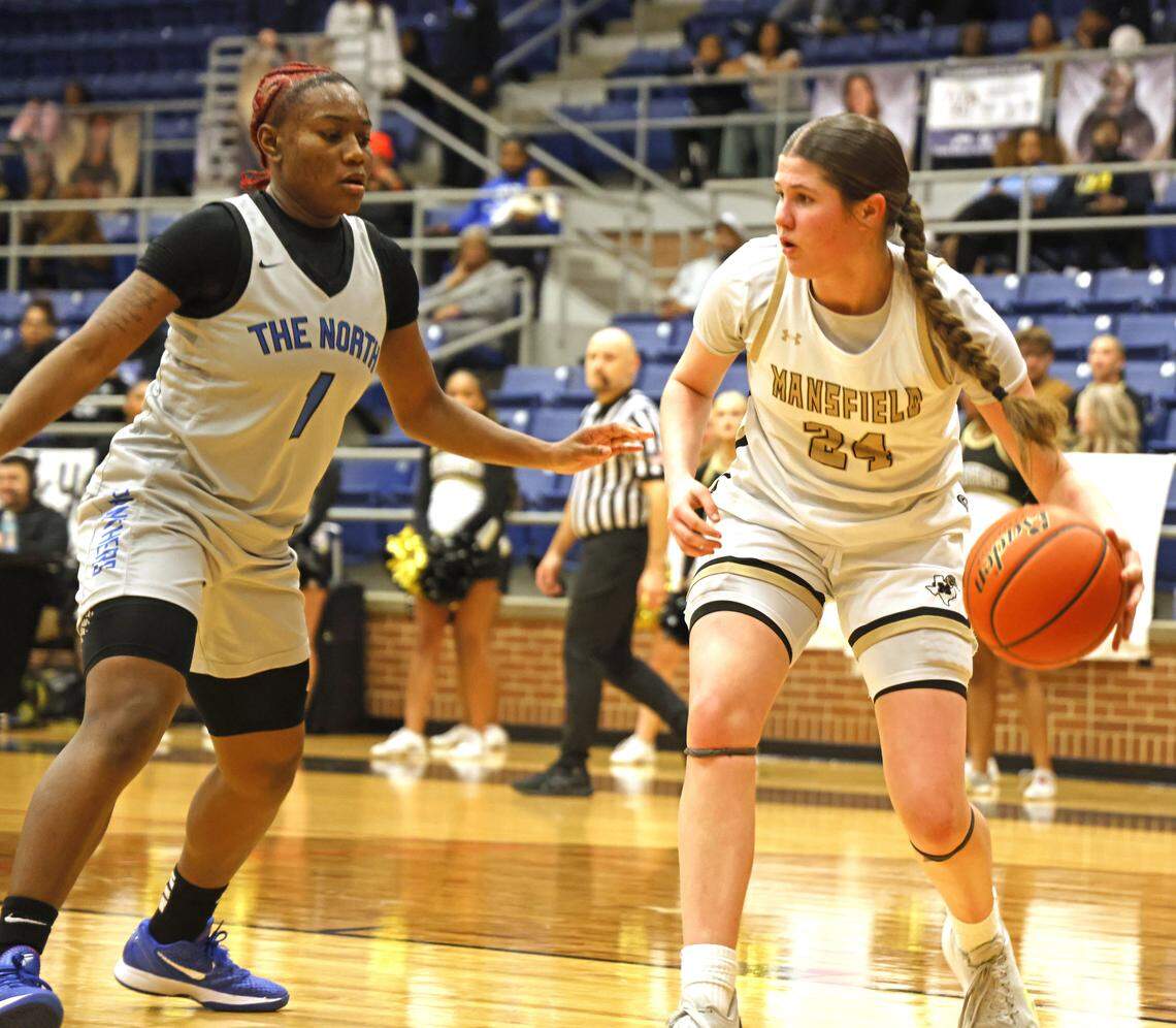 Mansfield shooting forward Kylie Farnan (24) grabs a rebound in front of North Crowley shooting guard Jamari Milton (1) during the first half of a UIL girls basketball game between North Crowley and Mansfield at Mansfield High School in Mansfield, Texas, Tuesday Jan. 20, 2026