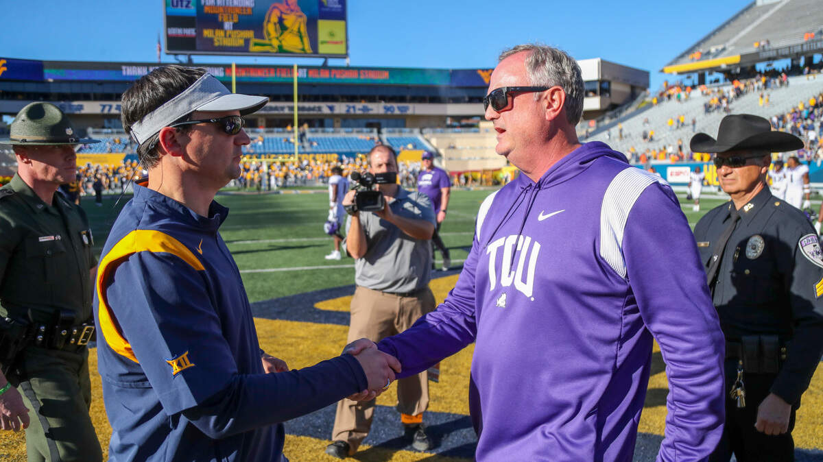 TCU Horned Frogs head coach Sonny Dykes talks with West Virginia Mountaineers head coach Neal Brown after their game in Morgantown in 2022.