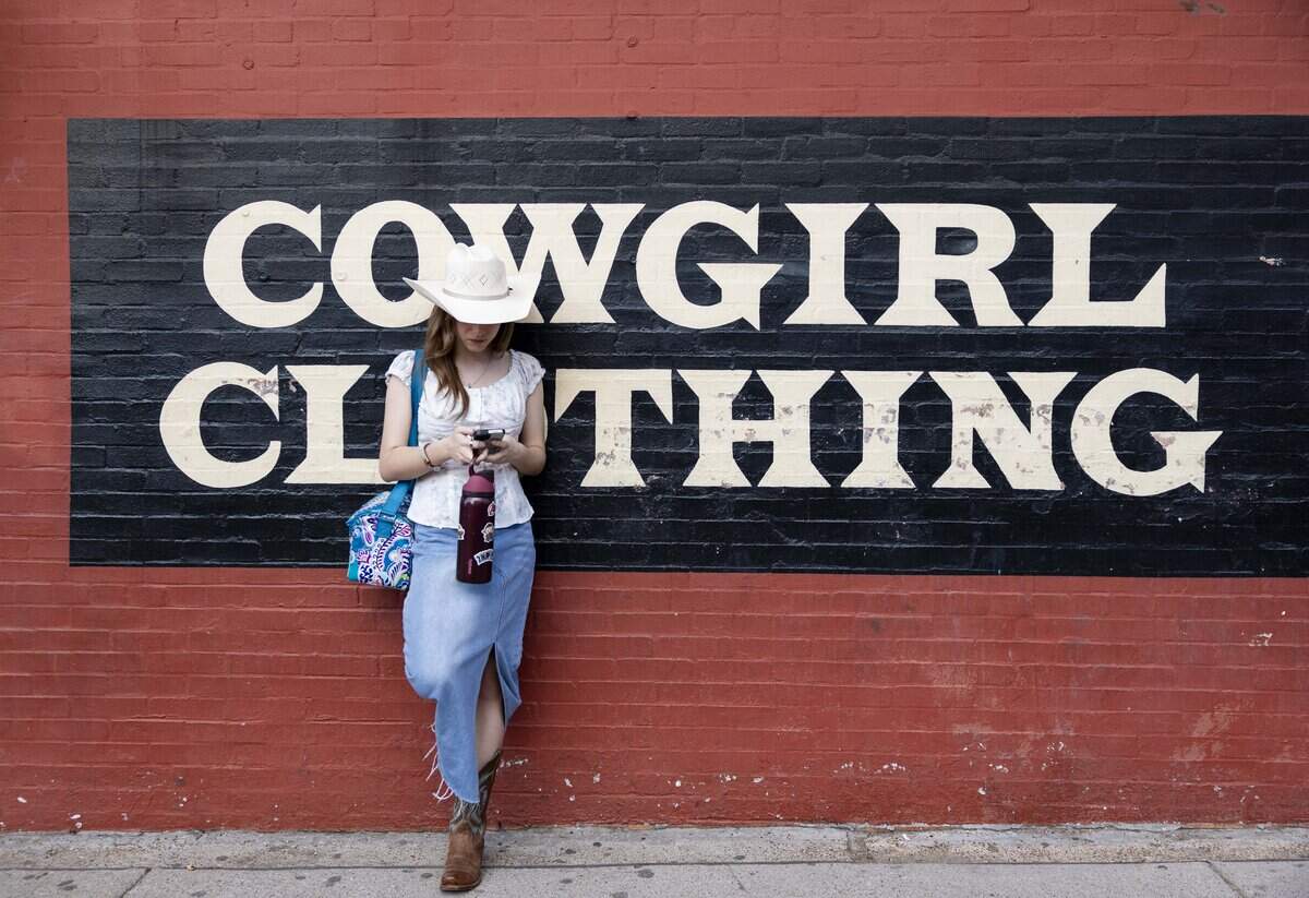 Karra Petit hangs out oustide of Maverick Western Wear on Friday, May 22, 2026 in Fort Worth, Texas. The store sells men's and women's western wear in the Fort Worth Stockyards.