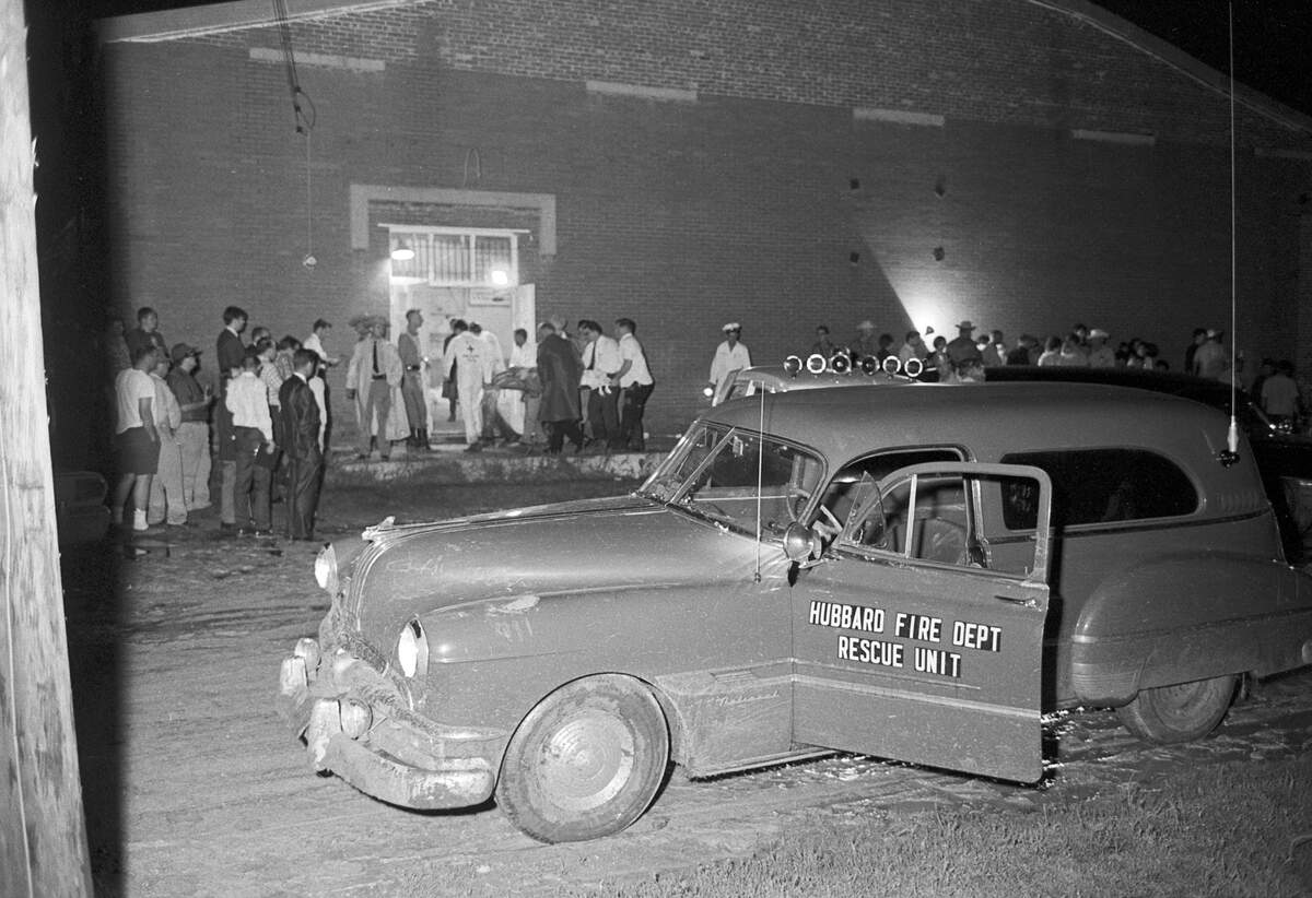 Pictured in the background is the school gymnasium in Dawson where volunteer workers set up a temporary morgue for victims of Texas’ worst air disaster to date.