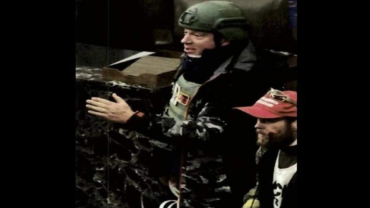 Larry Brock Jr. of Grapevine (left), wearing a helmet, was in the U.S. Capitol building on Jan. 6, 2021.