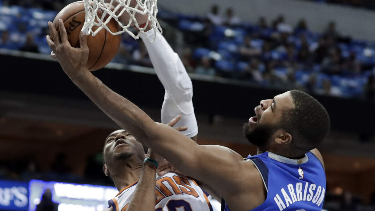 Phoenix Suns guard Shaquille Harrison defends as Dallas Mavericks' Aaron Harrison, right, attempts a shot in Tuesday's game.