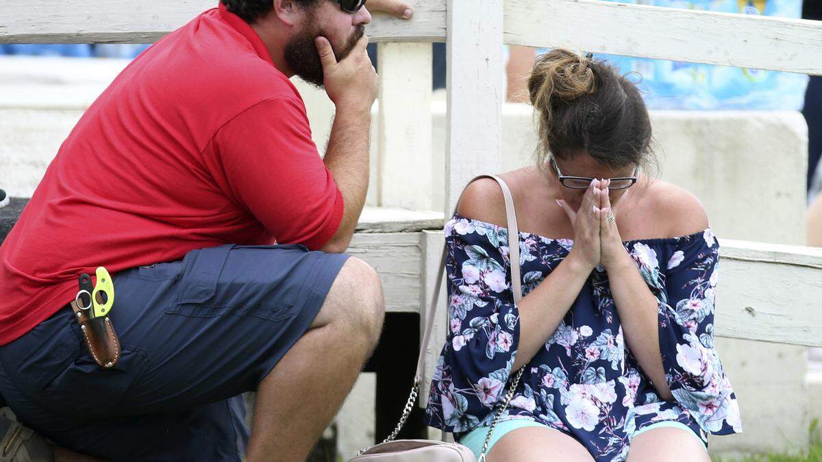 A woman prays outside the Santa Fe ISD Alamo Gym where students and faculty are being brought after a shooting at Santa Fe High School on Friday, May 18, 2018, in Santa Fe, Texas.
