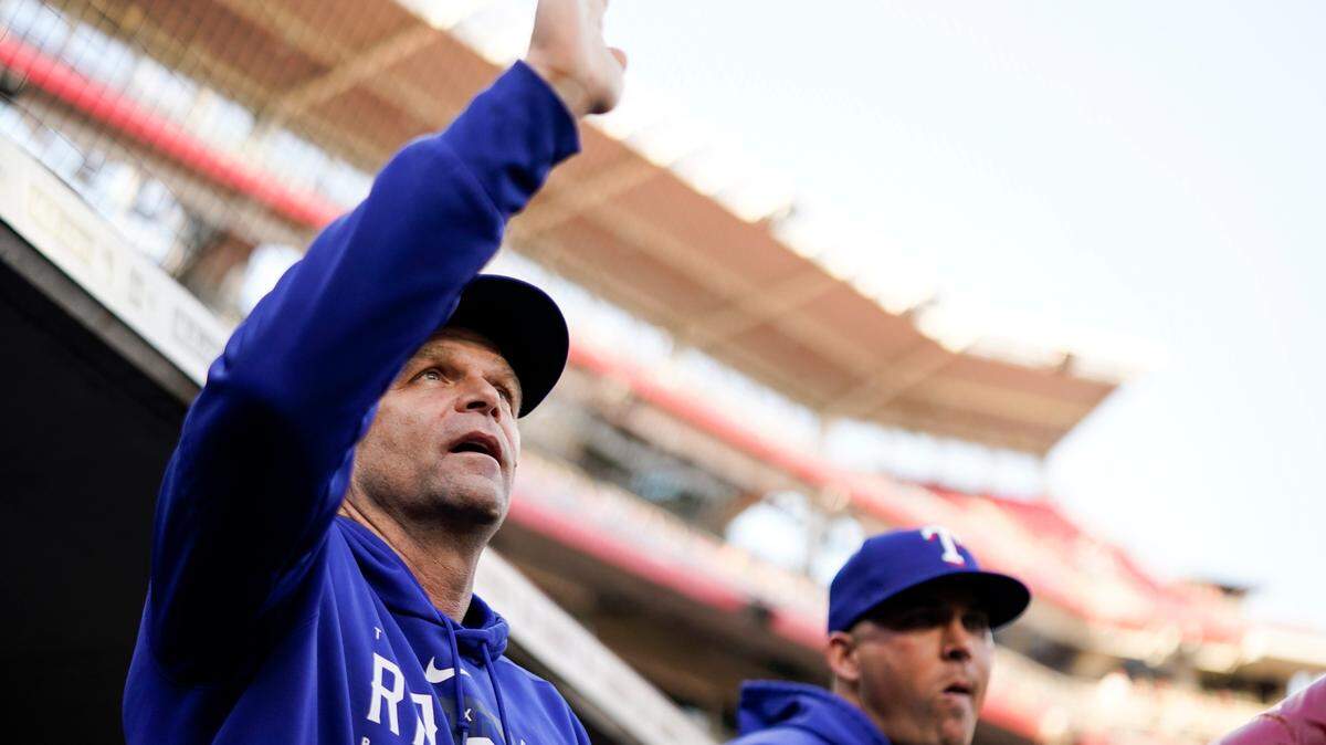 Hitting coach Tim Hyers, left, has guided the Rangers to the league’s top offense.