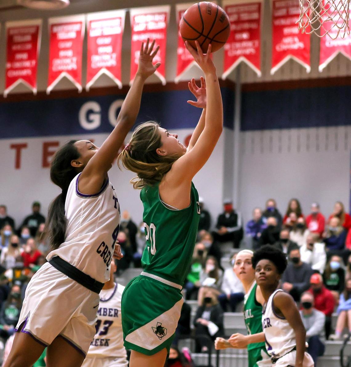 Southlake Carroll guard Camryn Tade (20) gets off a shot against Keller Timber Creek guard Mia Topping (4) during the second half of a 6A Region I Regional Quarter-Finals Girls Basketball playoff game played on Thursday, February 25, 2021 at Justin Northwest High School. (Steve Nurenberg Special to the Star-Telegram)