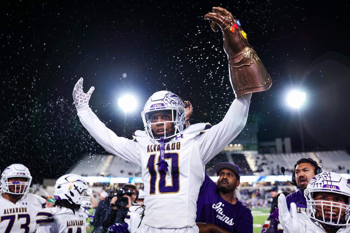 Alvarado defensive back Devin Johnson holds a Infinity Stone hand in celebration after forcing a turnover in a Class 4A Division I area playoff game against Sulphur Springs on Friday at Children’s Health Stadium in Prosper.