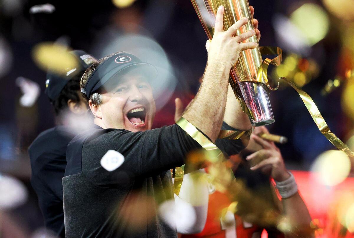 Georgia head coach Kirby Smith holds up the 2023 College Football Playoff National Championship trophy after defeating TCU on Monday, January 9, 2023, at SoFi Stadium in Inglewood, Calif.