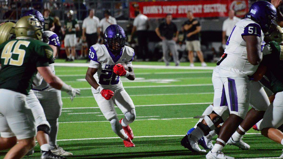 Crowley’s Keaton Roberts (75), left, and Trent Bunch (51), right, open a hole for running back Kenyen Cotton (20) to score on a seven-yard run against Birdville on Thursday, August 29, 2024 at the Birdville Fine Arts/Athletics Center in North Richland Hills, Texas. Crowley defeated Birdville 50-14.