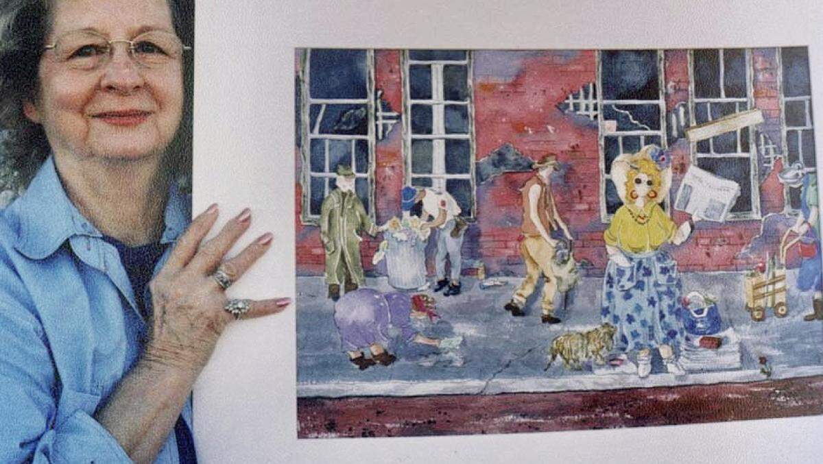Doris Mobley holds her watercolor painting featuring Kay Gale, a colorful woman who sold newspapers around Tarrant County Courthouse from the 1950s to the 1980s.