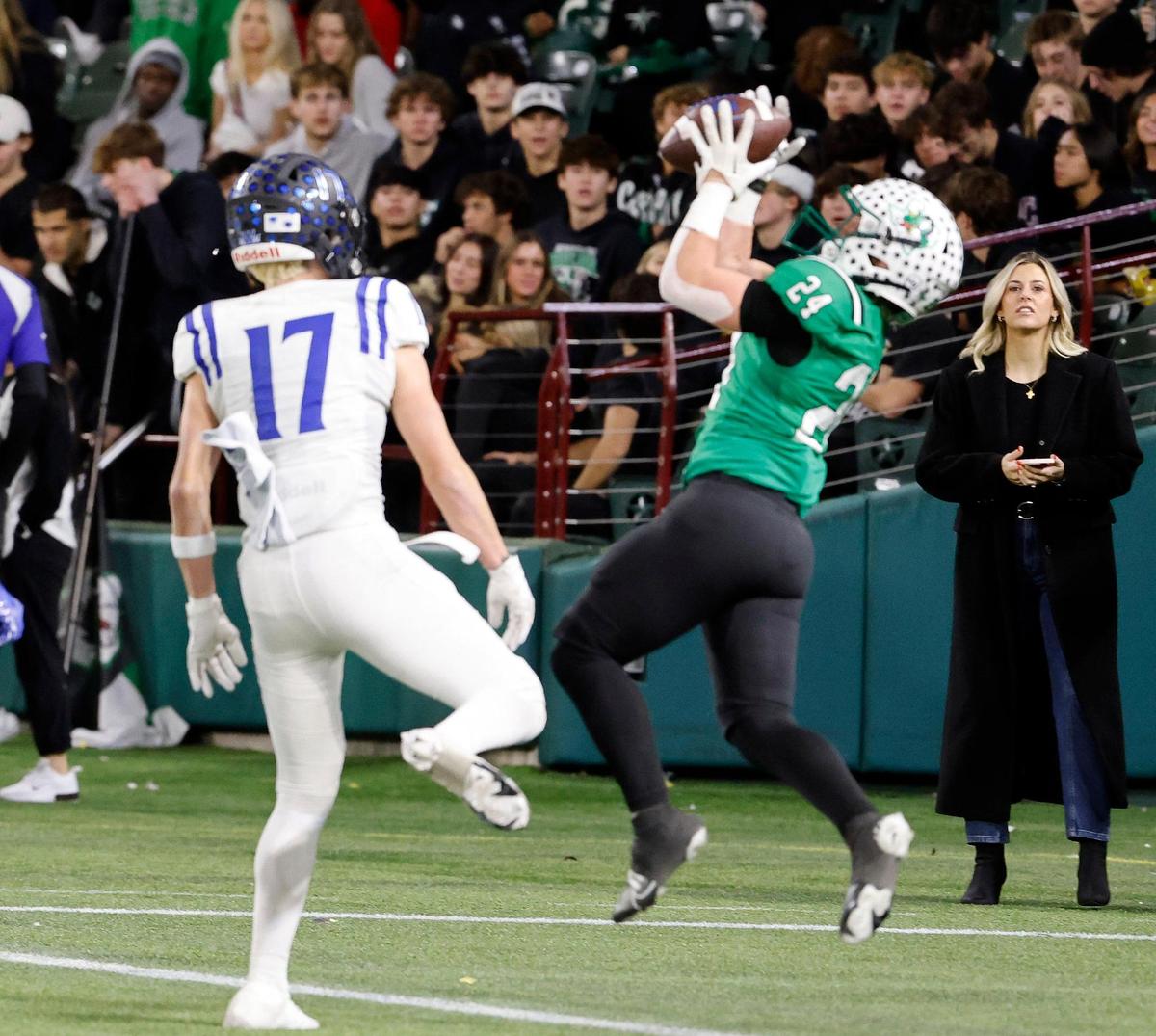 Carroll defensive back Clayton Smart (24) makes an interception on a Hail Mary pass in the end zone during the second half of a UIL Conference 6A Division 2 quarterfinal football playoff game at Choctaw Stadium in Arlington, Texas, Saturday, Dec. 02, 2023.
