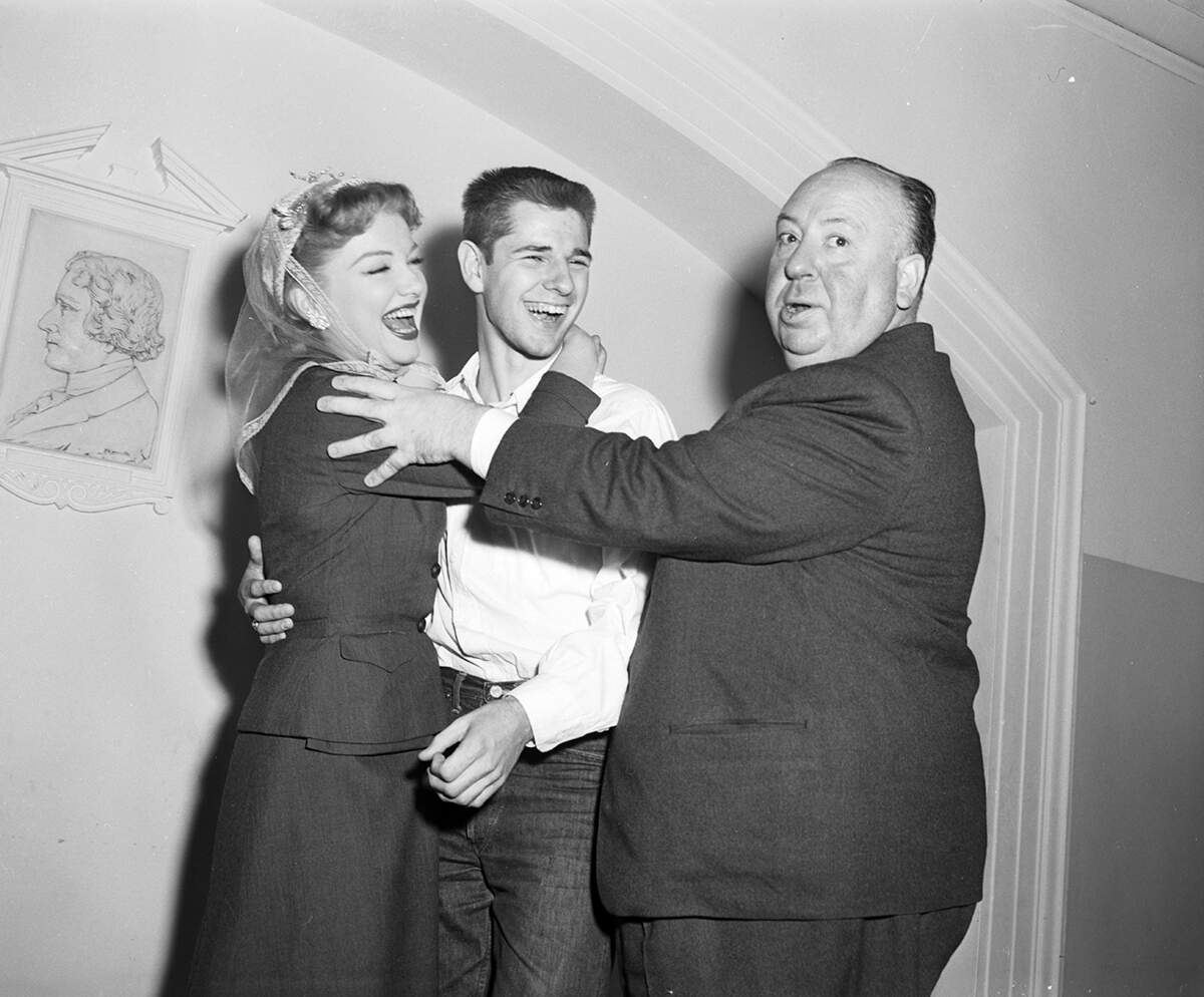 March 3, 1953: Alfred Hitchcock directs as actress Anne Baxter shows Don Olson how Hollywood does love scenes during a visit to Arlington Heights High School. Don, an 18-year-old senior, is the son of the Rev. and Mrs. Floydd H. Olson. Baxter starred in Hitchcock’s “I Confess” in 1953, and would play Nefretiri in the 1956 film “The Ten Commandments.”