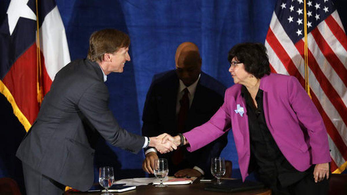 Texas Democratic gubernatorial candidates Andrew White, left, and Lupe Valdez, right, shake hands following their debate, Friday, May 11, 2018, in Austin, Texas. Valdez, her party's nominee, is now scheduled to debate incumbent Gov. Greg Abbott on September 28.