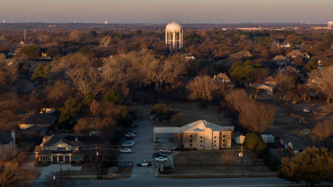 FILE - Police vehicles stand in front of Congregation Beth Israel synagogue, Sunday, Jan. 16, 2022, in Colleyville, Texas. A White House spokeswoman says an armed British man who took four people hostage during a more than 10-hour standoff on Saturday at the synagogue that ended in his death entered the United States without raising any red flags during multiple checks against law enforcement databases. (AP Photo/Brandon Wade, File)