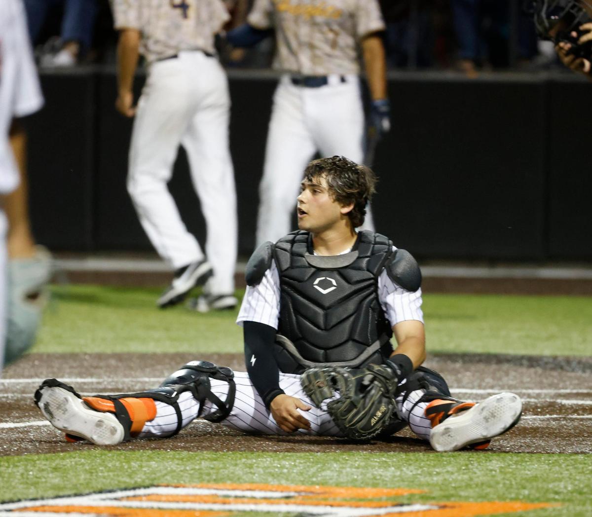 Aledo catcher Brennon Evans (13) sits at home in frustration after a wild throw to him during a UIL Area Round 5AD1 baseball playoff game at Bearcat Field in Aledo, Texas, Thursday, May 08, 2025.