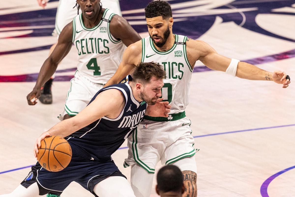 Dallas Mavericks guard Luka Doncic (77) drives to the basket on Boston Celtics guard Jayson Tatum (0) in the fourth quarter of game 3 of the 2024 NBA Finals at American Airlines Center in Dallas on Wednesday, June 12, 2024.