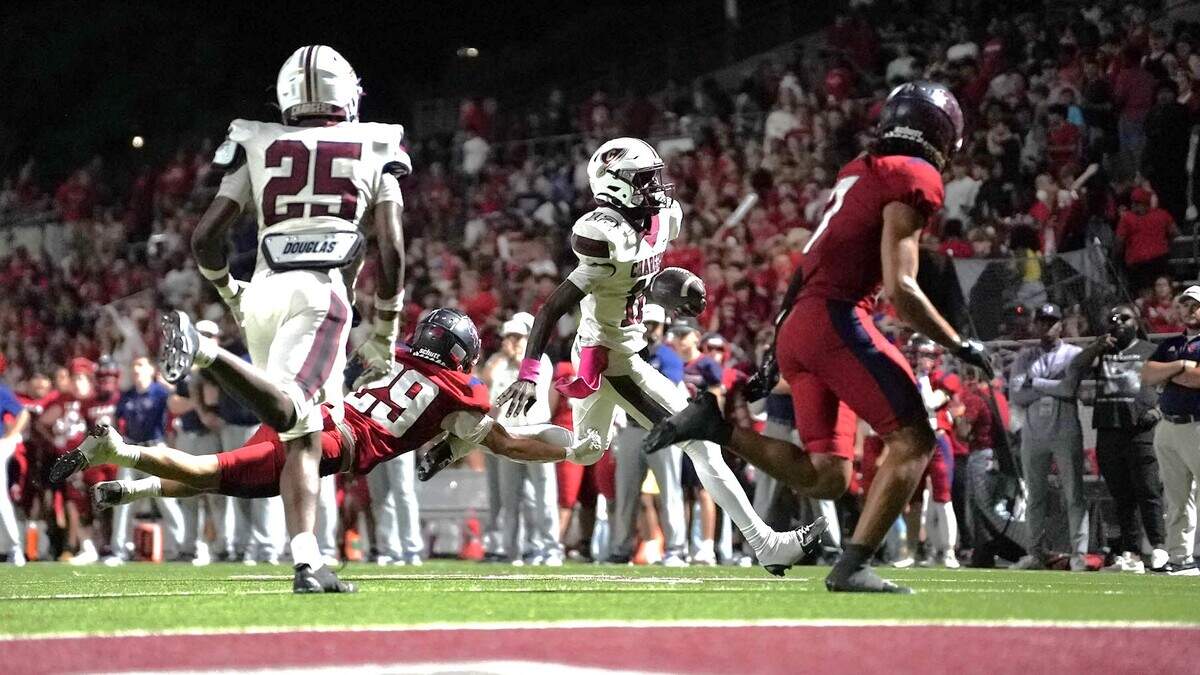 Keller Central quarterback Isaiah Taylor (12) runs toward the end zone as Justin Northwest’s Zephraim Gandy (29) dives in persuit on Friday, October 10, 2025 at Northwest ISD Stadium in Justin, Texas.