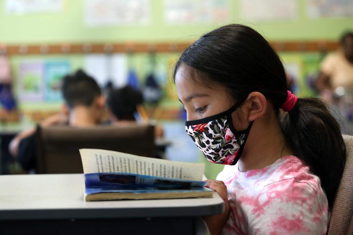 Maryjane Angel reads during a summer program to fight the “COVID slide” for young students at the United Community Centers (UCC) Polytechnic Center on Tuesday, July 13, 2021, in Fort Worth.