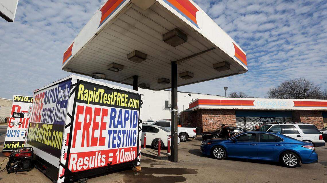 People wait in line at a drive-through COVID-19 testing site run by Grand Avenue Pharmacy at the intersection of Hemphill and Berry Streets on Monday, Dec. 27, 2021. The site is open from 9 a.m. to 7 p.m. every day of the week.