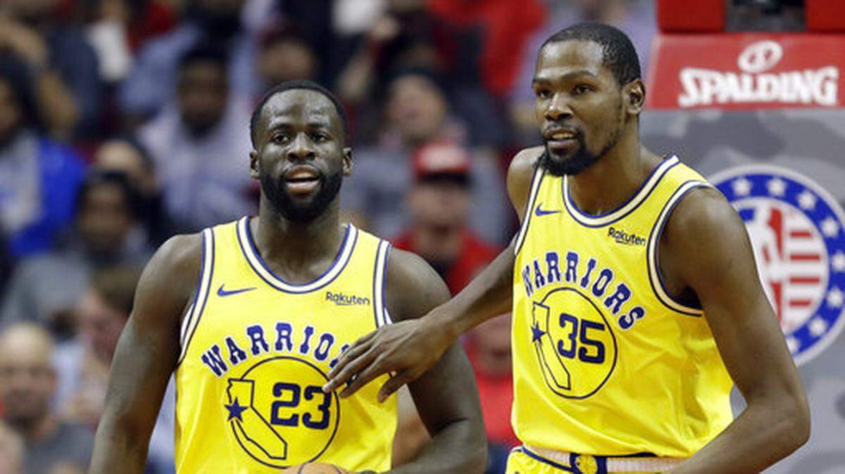 Golden State Warriors’ Kevin Durant (35) pats Draymond Green (23) on the chest after a turnover during the second half of an NBA basketball game against the Houston Rockets Thursday, Nov. 15, 2018, in Houston. (AP Photo/David J. Phillip)