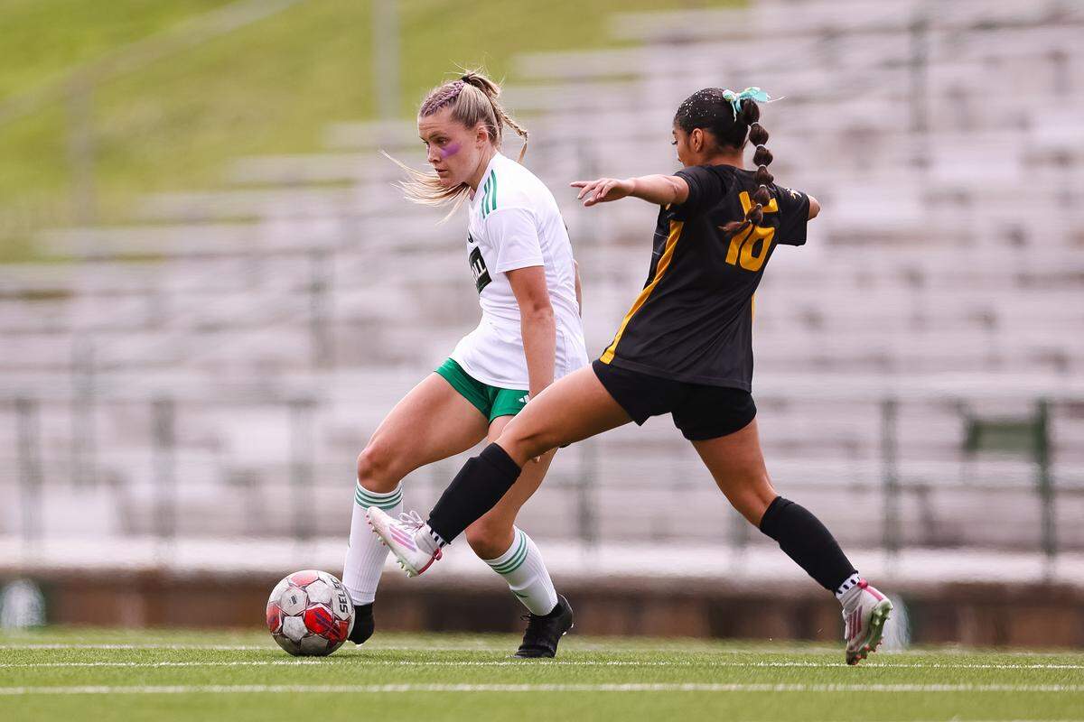Southlake Carroll striker Caroline Holcombe (9) dribbles the ball past the reach of a Forney defender in a UIL Class 6A Division 2 girls soccer state semifinal on Saturday, April 4, 2026, at Memorial Stadium in Mesquite, Texas.