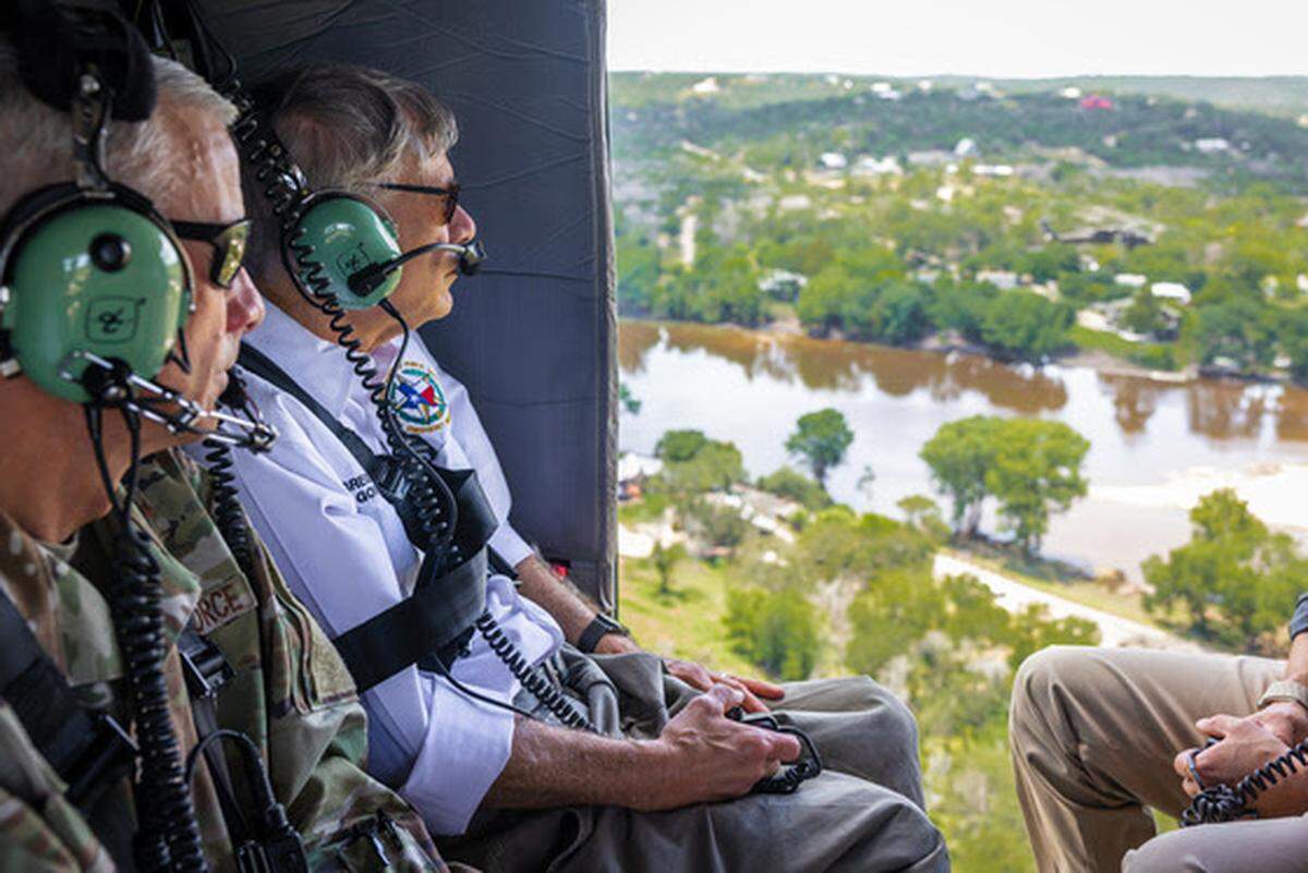 Officials take an aerial tour on Tuesday, July 8, to view areas devastated by flooding along the Guadalupe River in Central Texas.