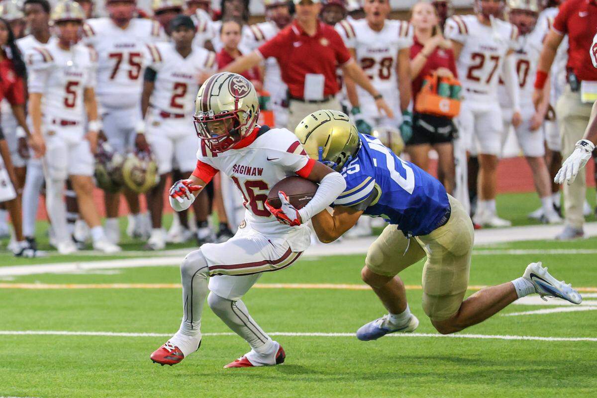 Saginaw receiver Derek Harris (16) is tackled by Boswell’s Isaiah Wade at Boswell Pioneer Stadium on Friday, Sept. 5, 2025.
