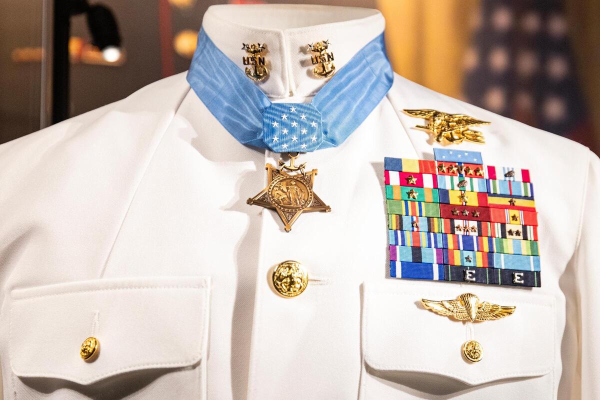 The full dress uniform and Medal of Honor worn by United States Navy SEAL Britt K. Slabinski on display inside of the National Medal of Honor Museum in Arlington.