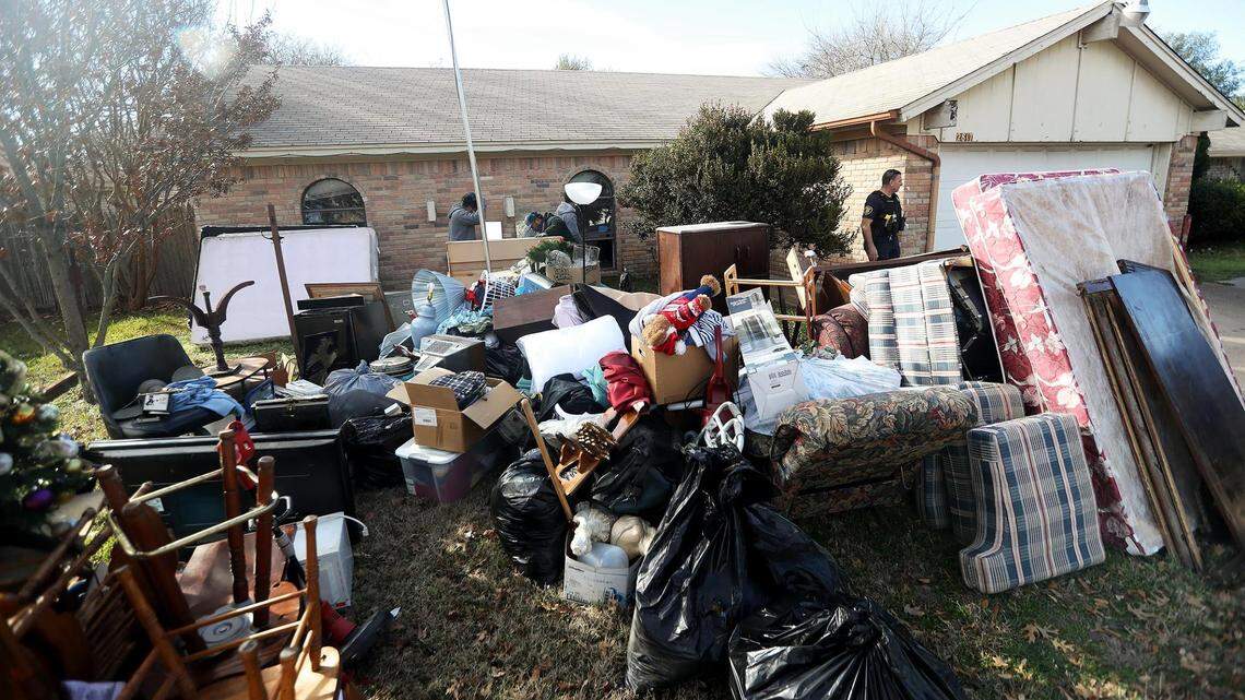A crew removes the possessions from a home in south Fort Worth in February. The Texas Supreme Court has extended the state’s eviction diversion program.