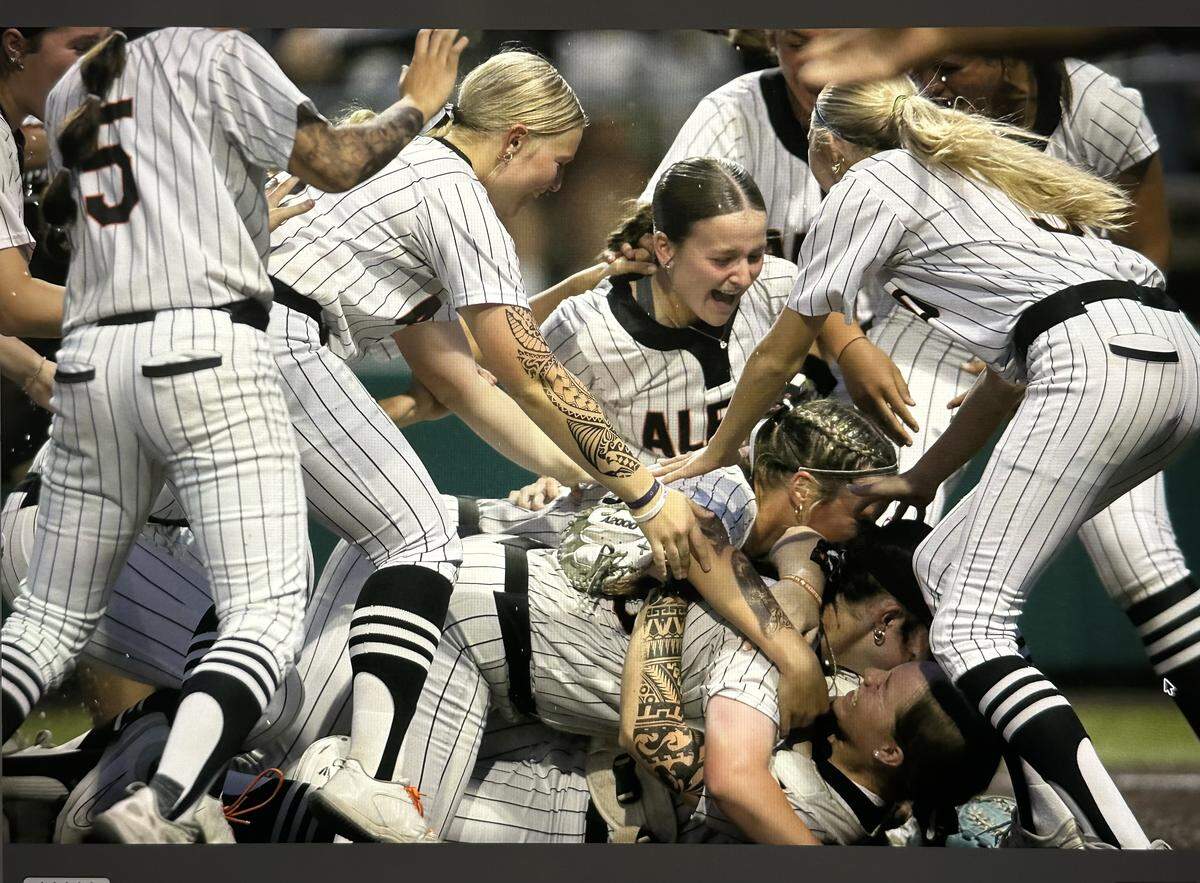 Aledo players celebrate a state semifinal win over Melissa with a dogpile at Denton High School in Denton, Texas, Wednesday, May 20, 2026.
