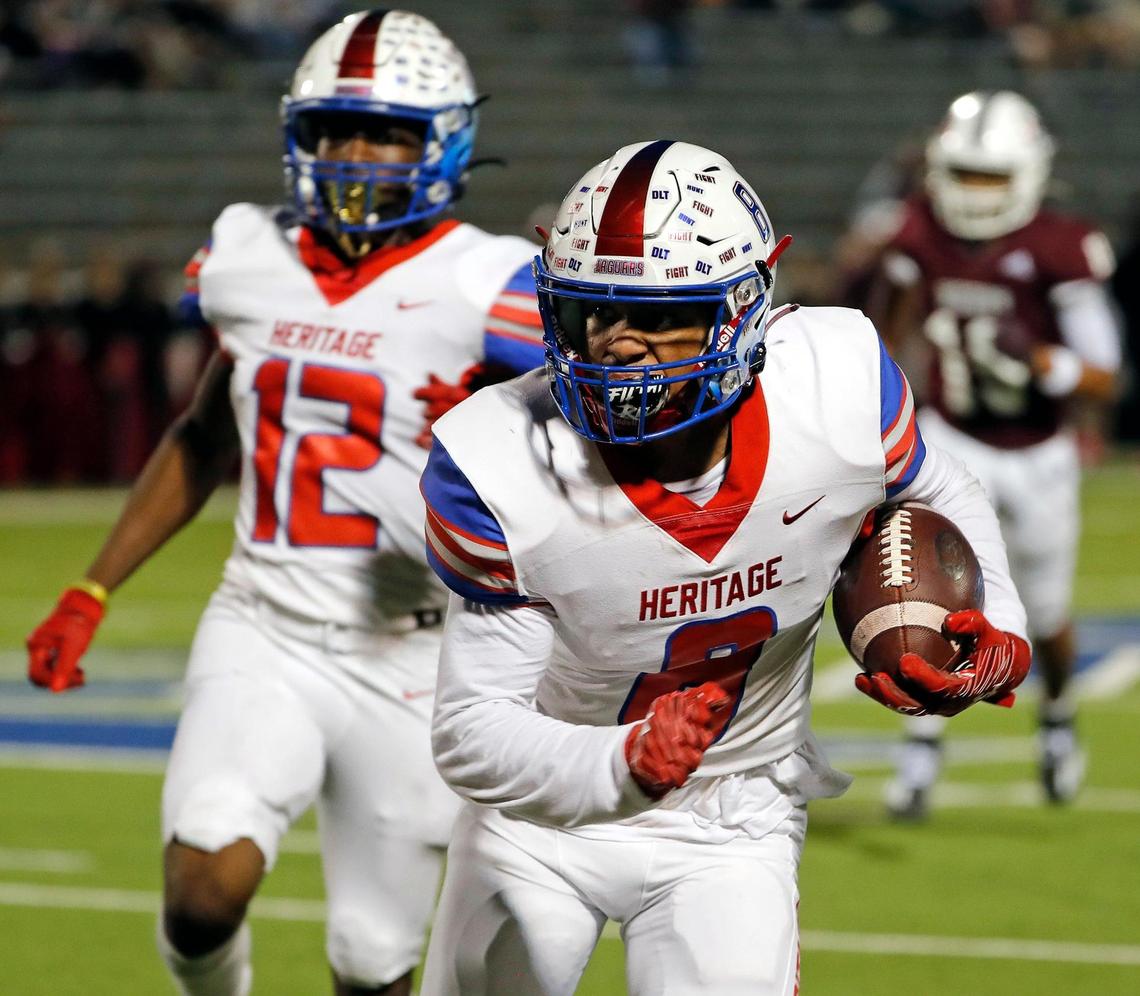 Heritage defensive back Solomon Hopkins (8) returns an interception for yards in the first half of a District 5-5A Division II high school football game at Midlothian ISD Multi-use Stadium in Midlothian, Texas, Friday, Oct. 14, 2022. Midlothian led Ennis 20-7 at the half. (Special to the Star-Telegram Bob Booth)
