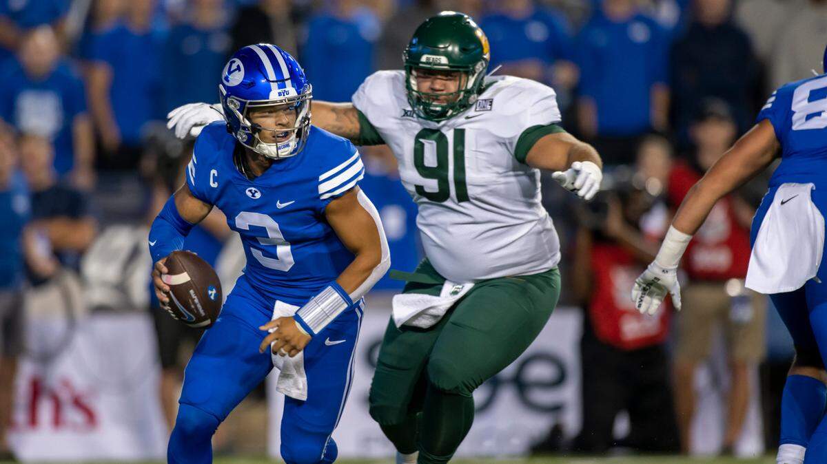 Brigham Young Cougars quarterback Jaren Hall (3) avoids the tackle from Baylor Bears defensive lineman Jaxon Player (91) during an NCAA football game on Saturday, Sept. 10, 2022 in Provo, Utah. BYU has another big game Saturday at Oregon. (AP Photo/Tyler Tate)