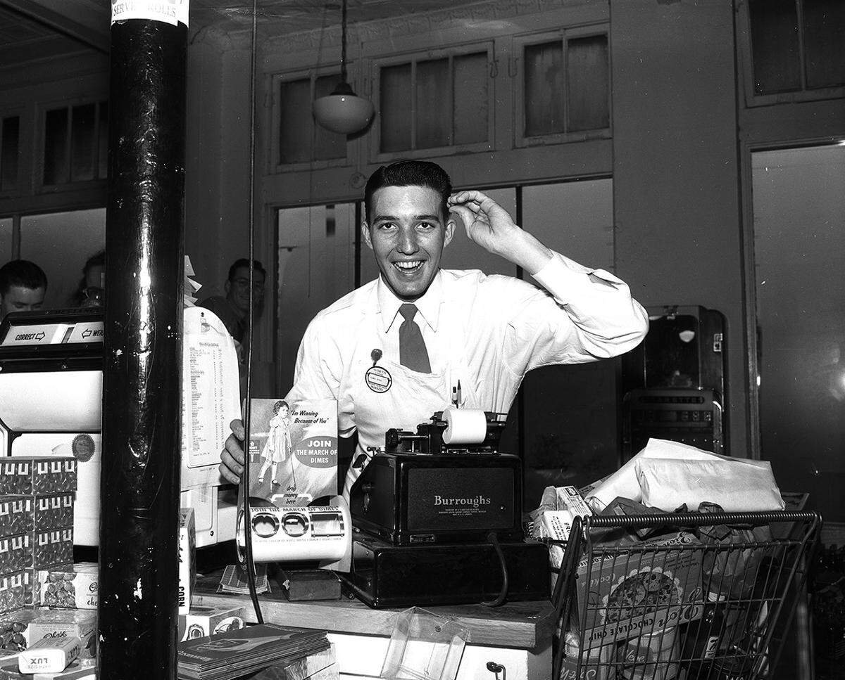 Jan. 18, 1950: Clem Nunn, checker at the Worth Food Market No. 9, 705 North Sylvania, is glad to be back on the job after a bout with polio. At the cash register is a can for March of Dimes.