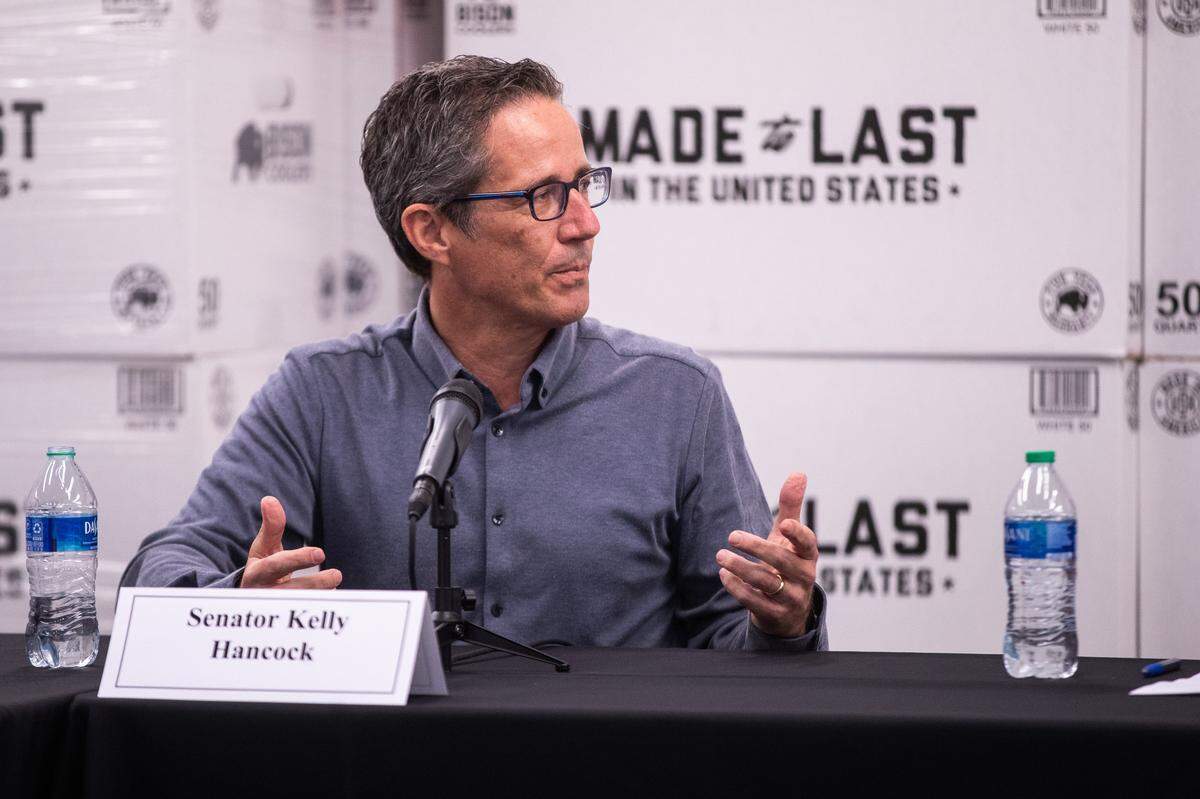 Senator Kelly Hancock joined Governor Greg Abbott to chat with Bison Coolers employees about a bill to protect businesses from COVID-related liability lawsuits Monday, March 22, 2021, in North Richland Hills.