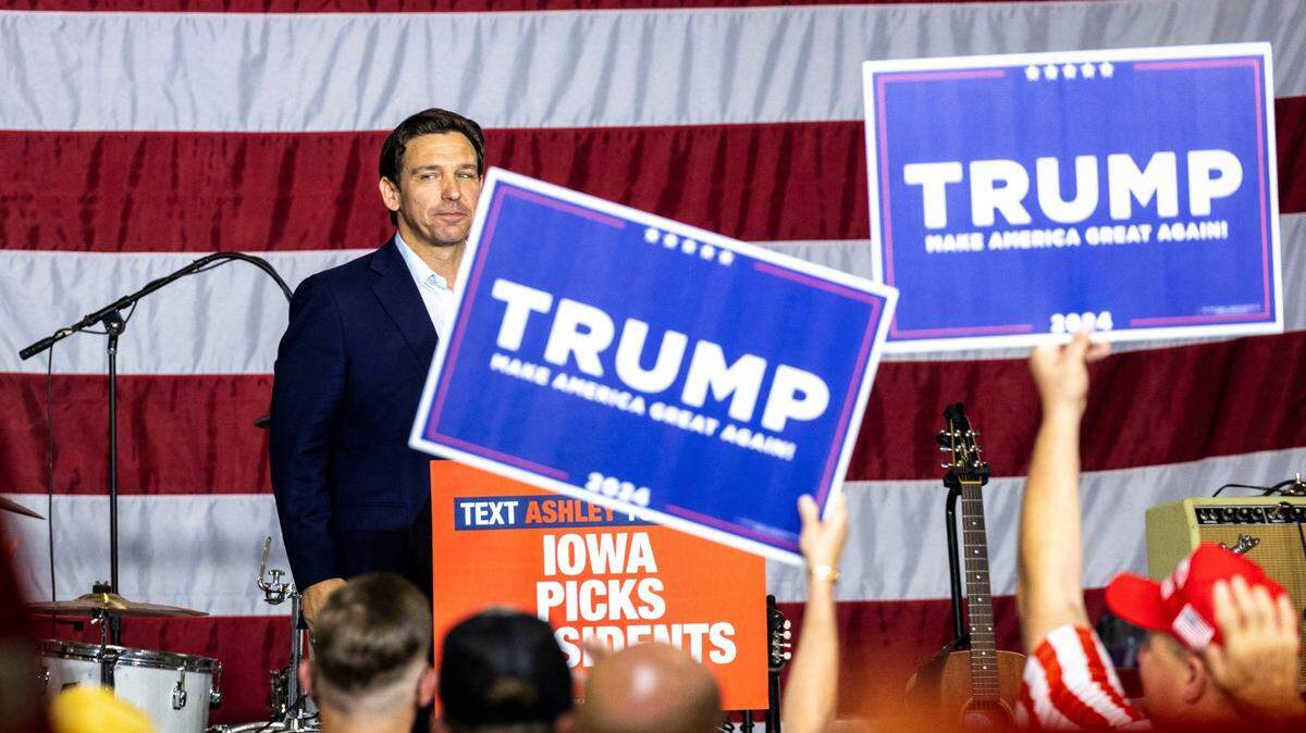 Republican presidential candidate Florida Gov. Ron DeSantis looks into the crowd after speaking as supporters of former President Donald Trump hold up signs during the Ashley’s BBQ Bash fundraiser on Aug. 6, at Hawkeye Downs in Cedar Rapids, Iowa.