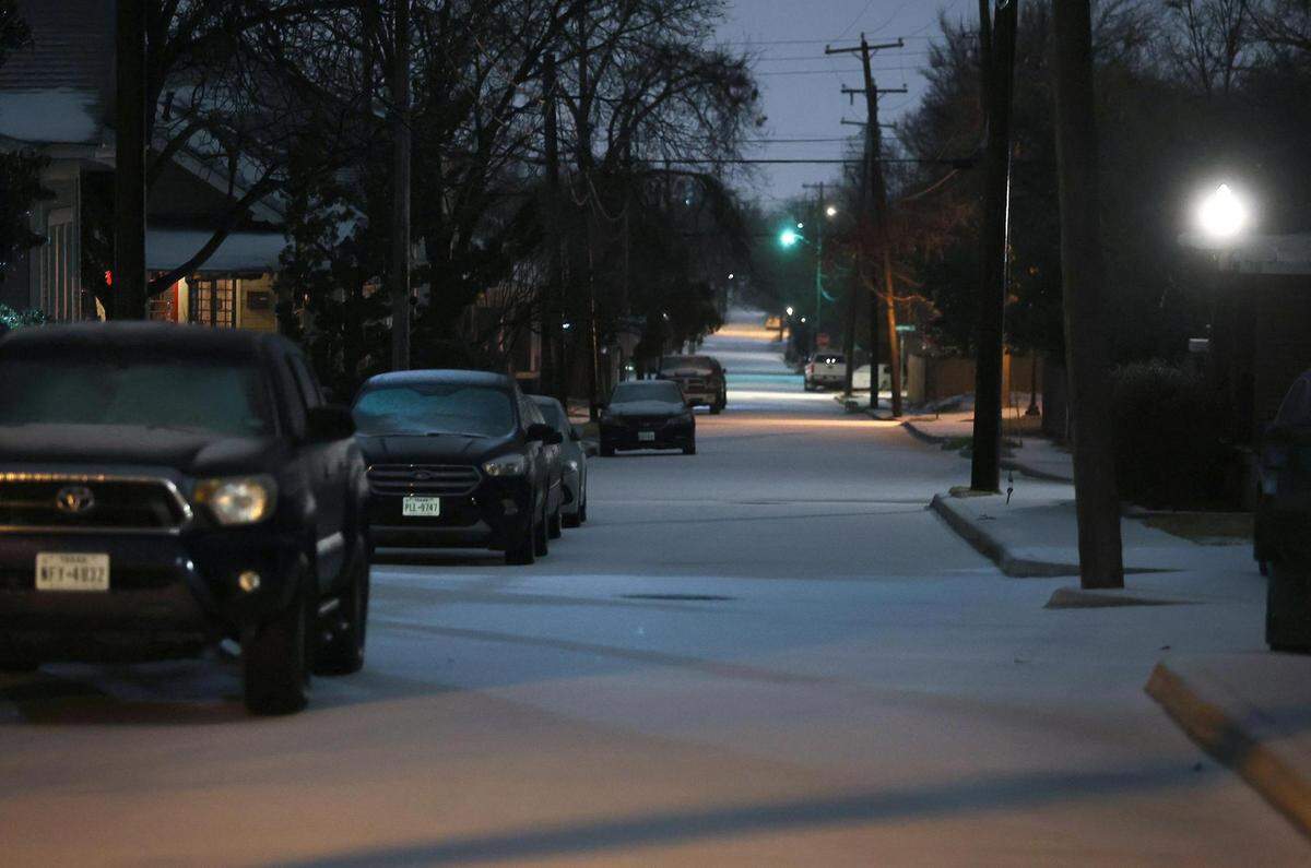 Snow covers the roads in the Fairmount neighborhood of Fort Worth before the sun rises on Thursday, February 3, 2022. North Texas was under a winter weather warning until 6 p.m. Thursday, but icy conditions may not begin to improve until Saturday.