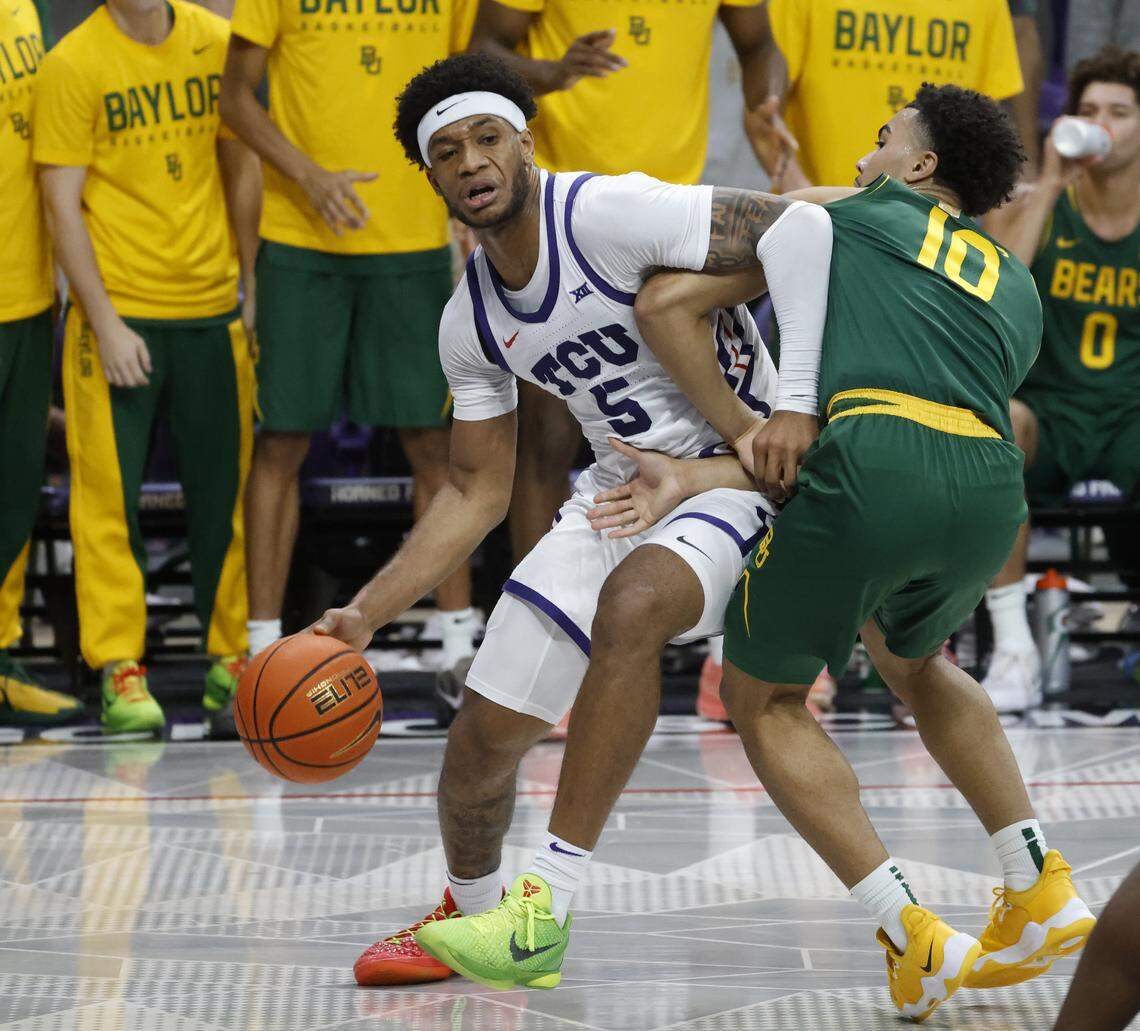 TCU forward Micah Robinson (5) battles Baylor guard Isaac Williams IV (10) in front of the Bear's bench during the first half of a NCAA basketball game between Baylor University and TCU at Schollmaier Arena in Fort Worth, Texas, Saturday Jan. 03, 2026