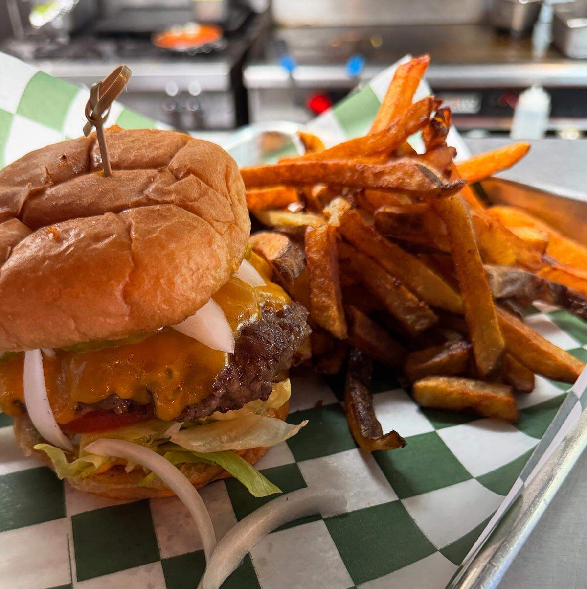 A cheeseburger with french fries July 26, 2025 at Our Taphouse in Near Southside Fort Worth, Texas.