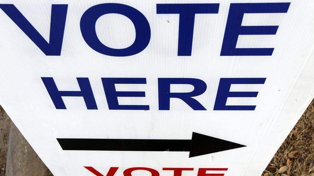 A voting sign is pictured.