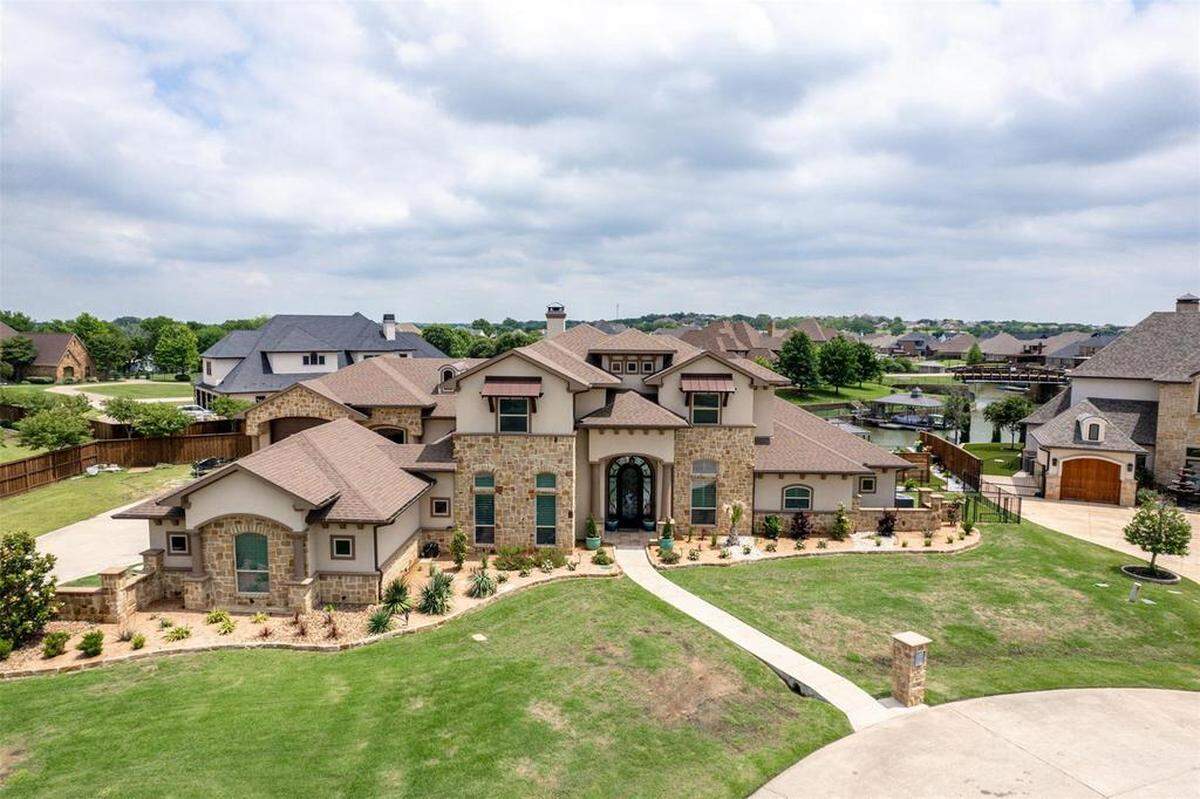 12516 Lake Shore CT N in the Resort at Eagle Mountain Lake. You can see boat docs behind the house in the private canal.