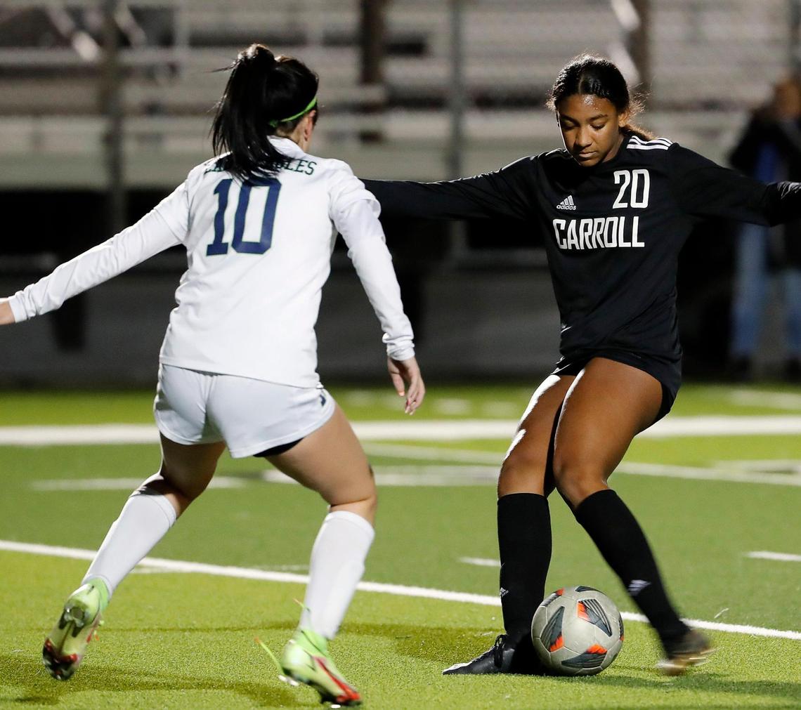 Carroll’s Zoe Matthews taps the ball past Eaton’s Madison Blue during a high school girls soccer game at Dragon Stadium in Southlake, Texas, Wednesday, Feb. 09, 2022. Carroll defeated Eaton 8-1. (Special to the Star-Telegram Bob Booth)