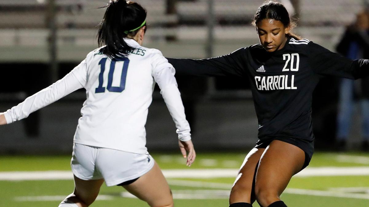 Carroll’s Zoe Matthews taps the ball past Eaton’s Madison Blue during a high school girls soccer game at Dragon Stadium in Southlake, Texas, Wednesday, Feb. 09, 2022. Carroll defeated Eaton 8-1. (Special to the Star-Telegram Bob Booth)