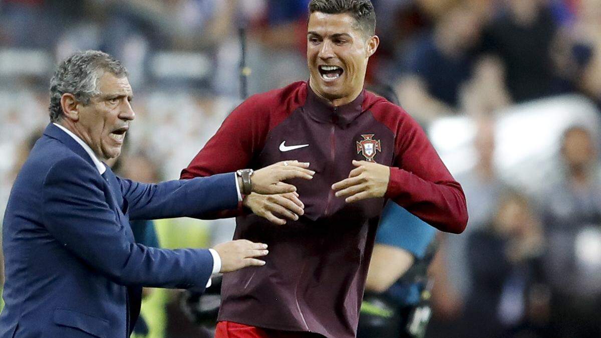 Portugal’s Cristiano Ronaldo and Portugal coach Fernando Santos react moments before the end of the Euro 2016 final soccer match between Portugal and France at the Stade de France in Saint-Denis, north of Paris, on July 10, 2016. The last 32-team World Cup will be the shortest in this era. There are just 28 days from starting on Nov. 21 in Qatar to finishing on Dec. 18.