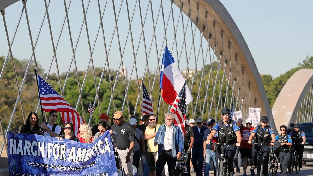 Marchers cross the Seventh Street bridge on the way to the Tarrant County Courthouse on Saturday to show their support for first responders.