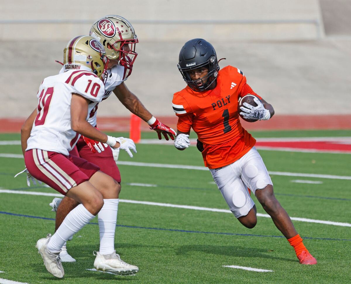 Polytechnic wide receiver Natnael Ghebrelibanos (1) runs into the defense of Saginaw defensive back Johnathan Barajas (10) and linebacker Isaiah Quinones (28) during a UIL football game at Farrington Field in Fort Worth Saturday, Sept. 14, 2024.