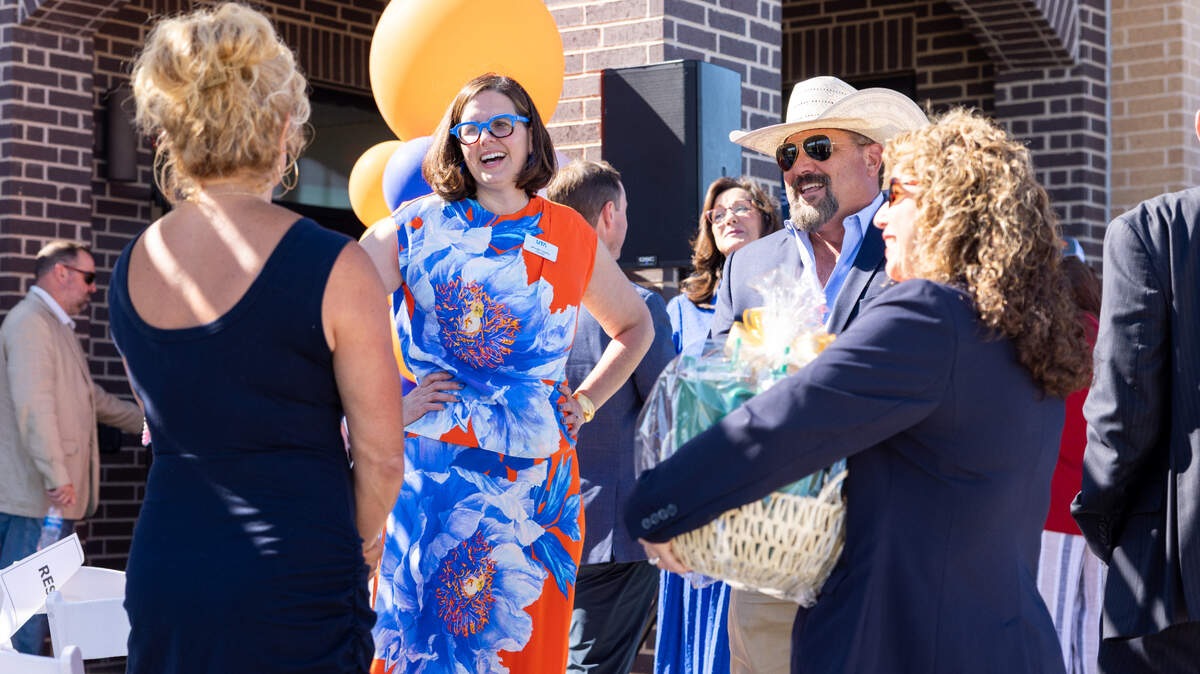 UTA President Jennifer Cowley speaks with local members of the far west Fort Worth Community at the ribbon-cutting ceremony for the new UTA West Storefront in Willow Park.